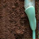 Soil sample tube inserted into ground, representing site analysis and soil testing.