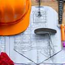 Garden tools and blueprints laid out on a table, symbolizing installation planning.